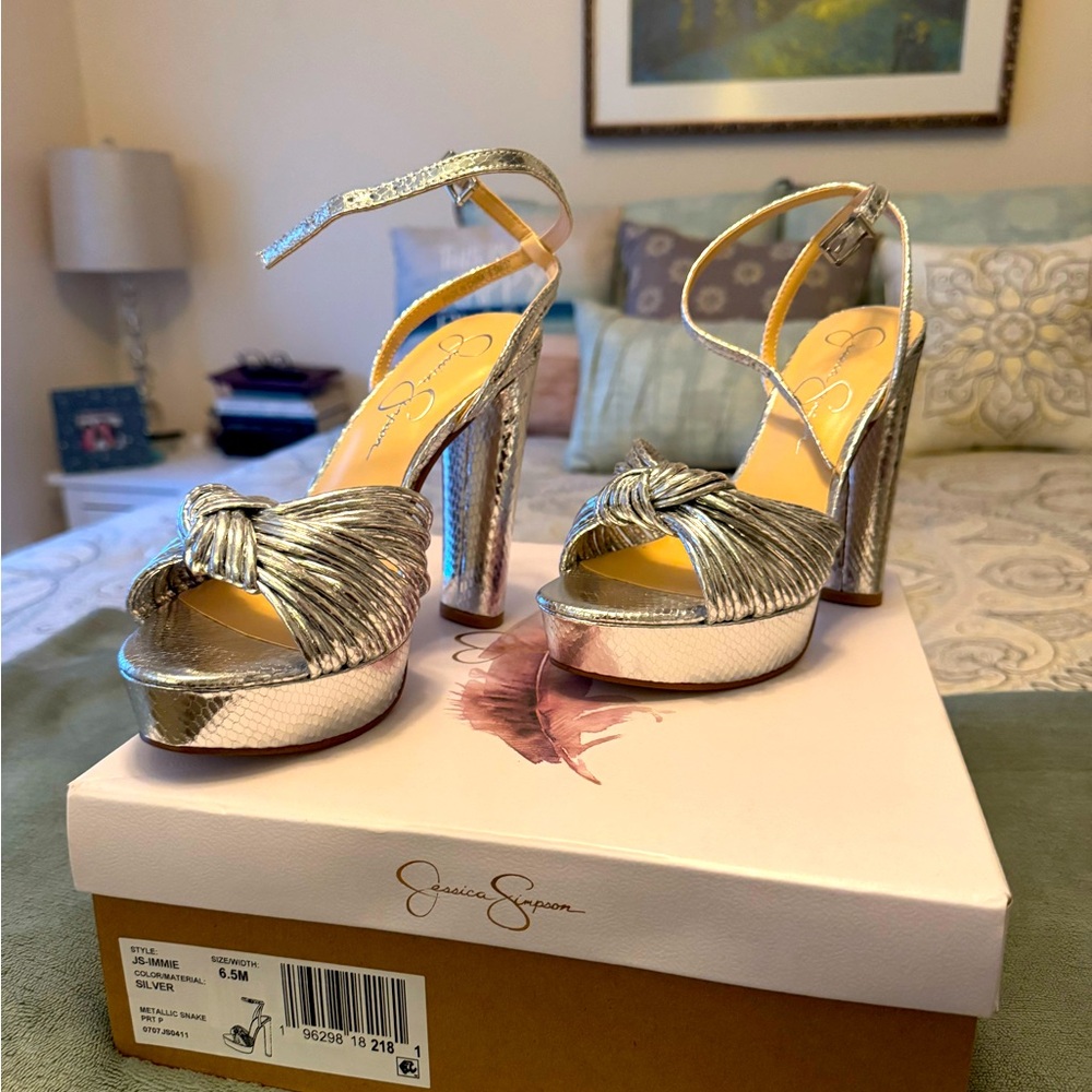 Beautiful/sleek silver chunky heels sure to make any dress dazzle. Never worn.